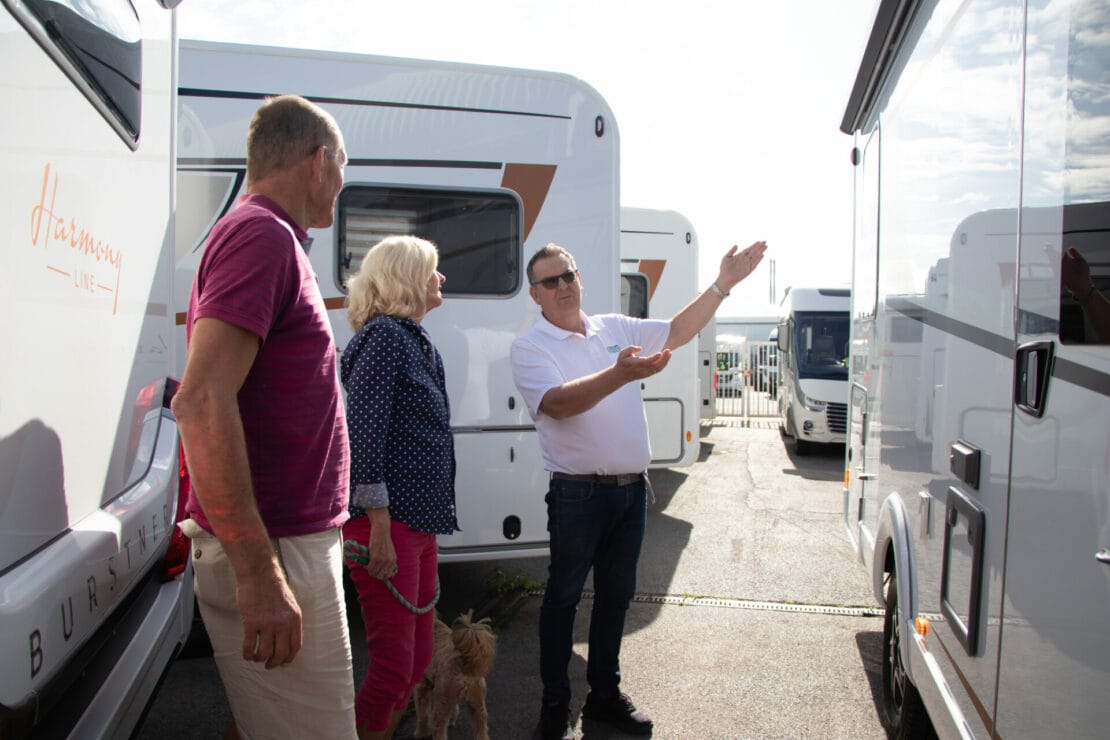 Showing customers a motorhome outside showroom