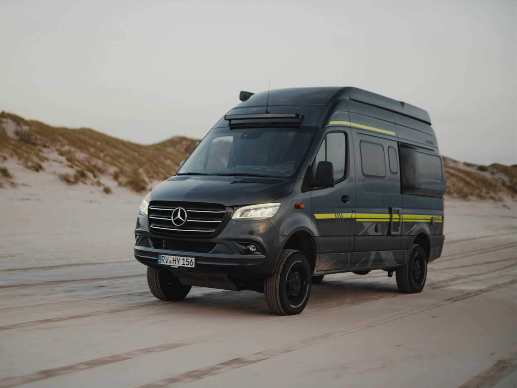 Hymer Grand Canyon S Crossover Campervan - Lifestyle Exterior Front Left Beach