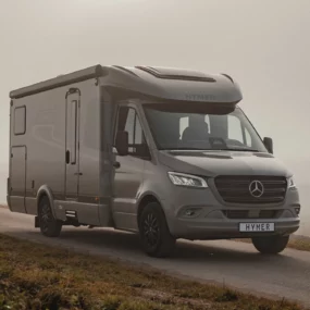 12302 Hymer GT-S 685 Stone Motorhome - Lifestyle Exterior Front Right Road